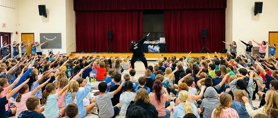 R-E-S-P-E-C-T performer engaging a school audience
